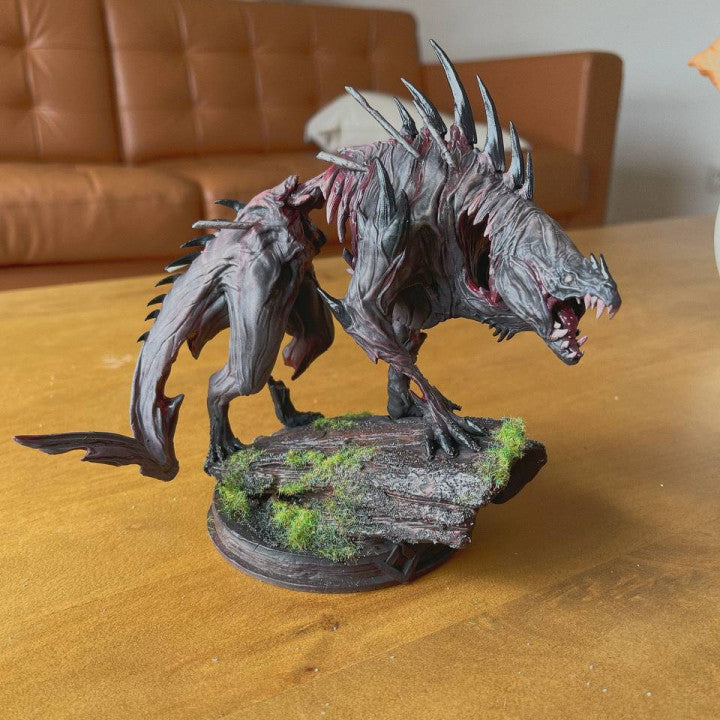 Painted Beast of Vaudange miniature showing snarling head, blood details, and scenic mossy base.