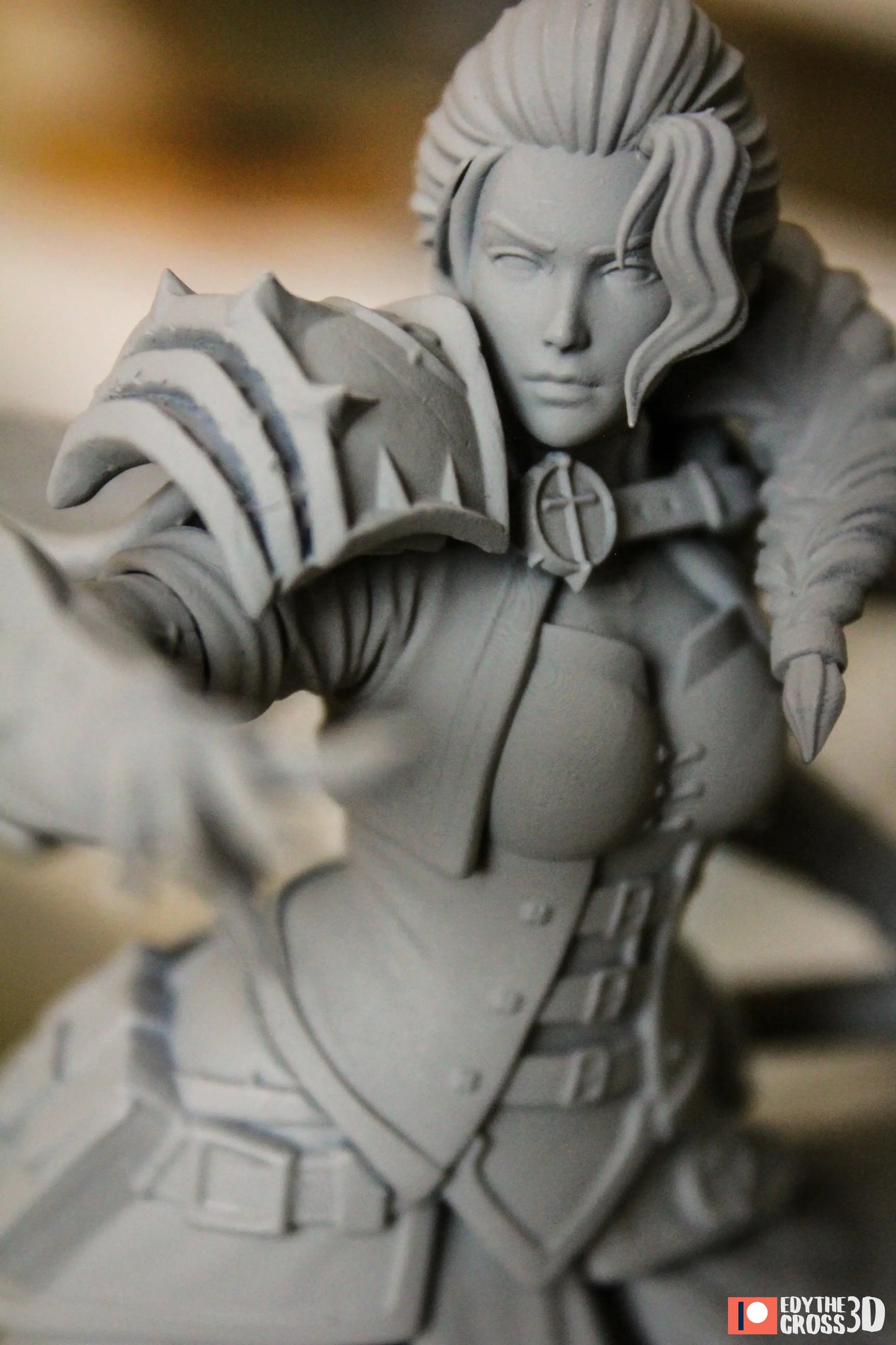 Gray 3D-printed figurine with intricate details on a blurred background