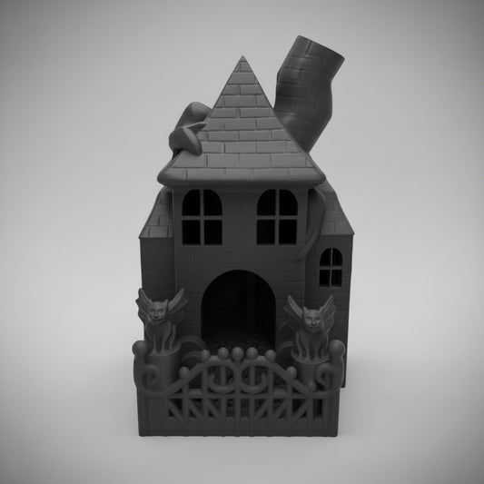 Straight-on front view of the black Haunted House dice tower displaying the front entrance arched doorway and fenced dice catching area.