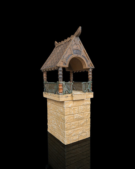 Close up of an elven watchtower resin terrain kit with stone brick base, mid floors, and multi-part wooden tiled roof structure.