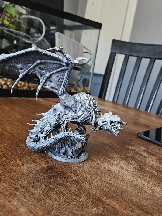 3D printed Elder Brain Dragon miniature shown unpainted on tabletop.