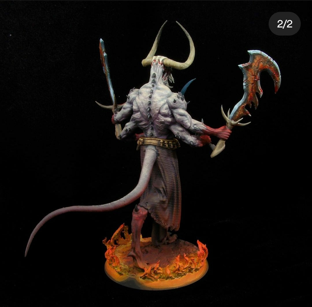 Back view of the painted Moloch miniature showcasing his whip-like tail, spine spikes, and the back of his tattered brown loincloth surrounded by flames.