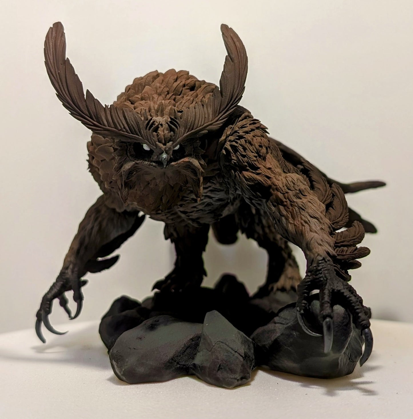 3D printed Titancrest Owlbear resin monstrosity with layered feathers and sharp talons posed on a rocky base