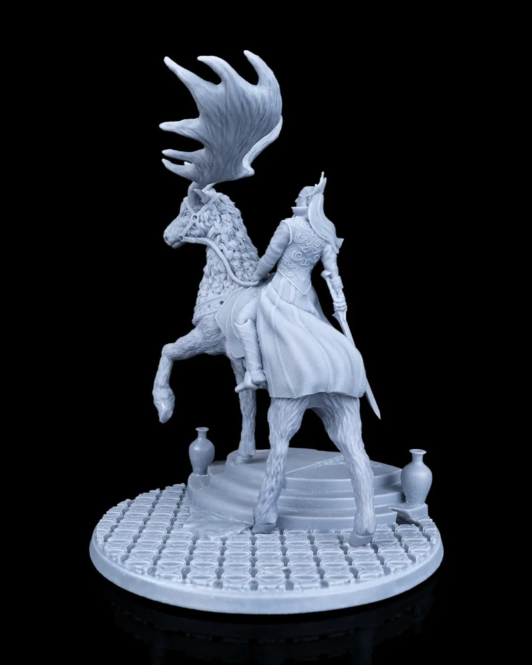 Left side profile view of the unpainted miniature showing the elk stepping up on the stone stairs with ornamental urns.