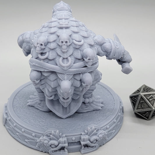 Zylotl Grimeye Tortle Fighter miniature showing his broad shell and heavy build.
Focal Point: Shell and shoulders.