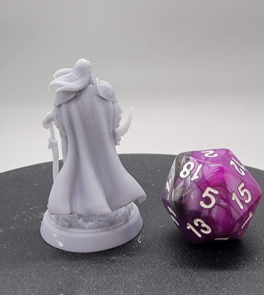 Levin Elven Ranger resin miniature standing beside a D20 die, featuring detailed armor, bow, and flowing cloak. Available in 32mm and 75mm scales.