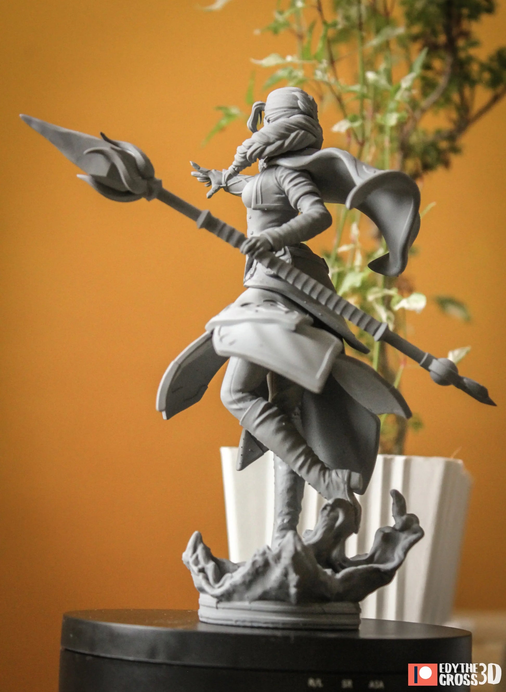 side/back angle highlighting cape and staff
