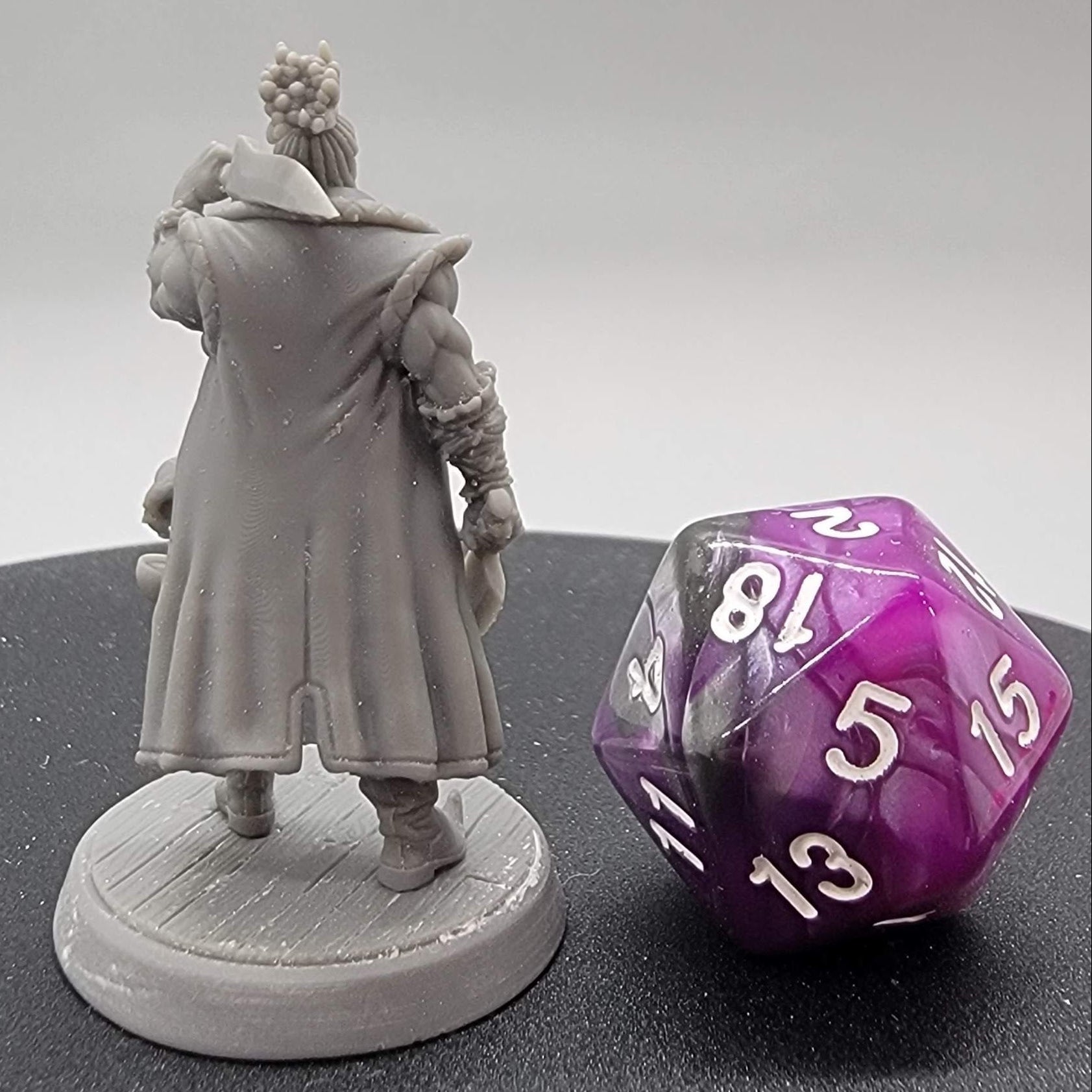 32mm TTRPG named Grub showing the intricate details of 16K resolution resin printing at its finest. You can even see the woodgrain on the base.