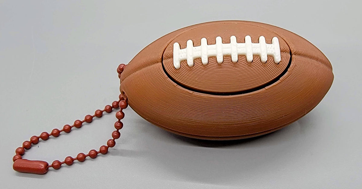 3D printed football keychain ball clicker toy with white lace clicker detail
