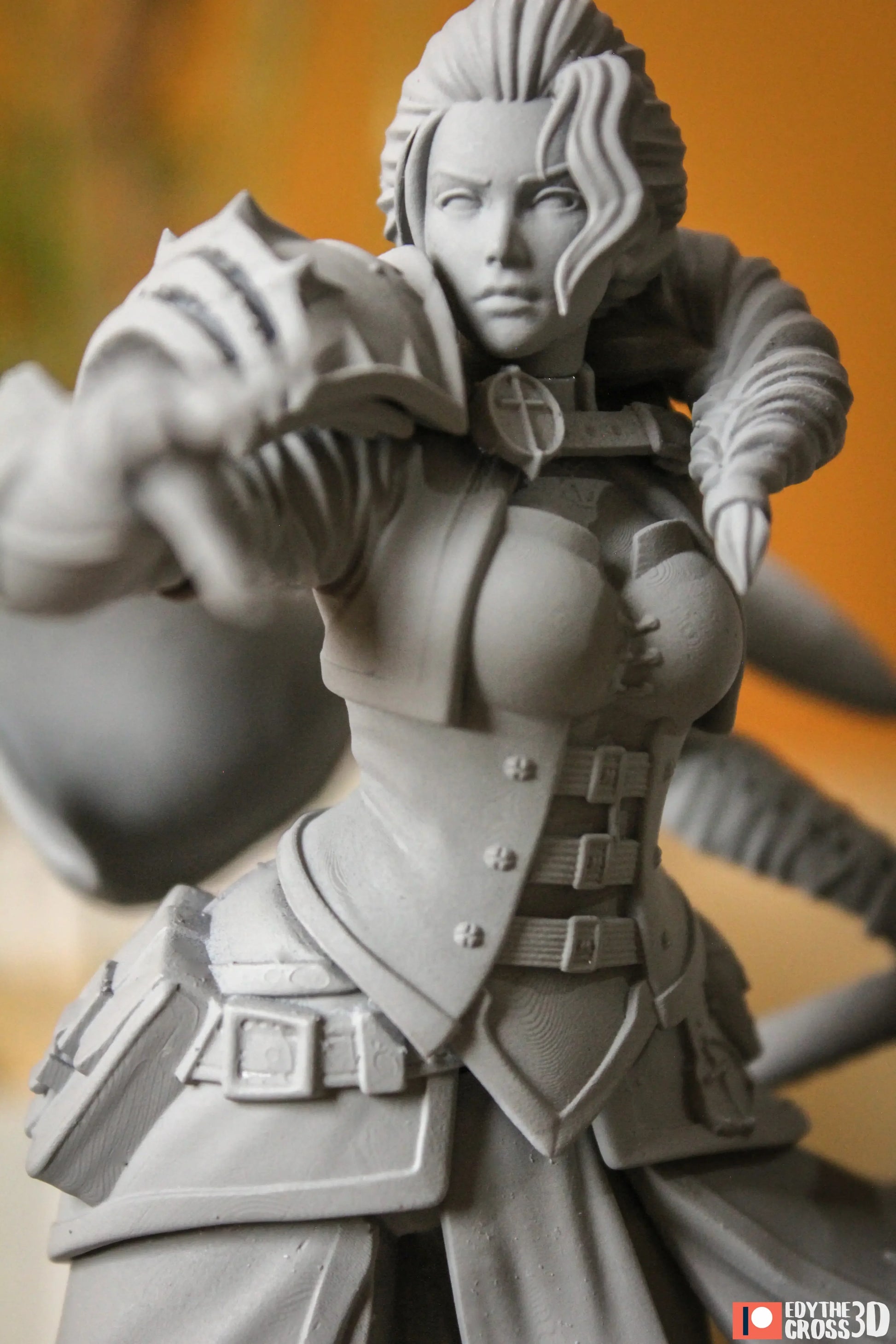 Gray figurine of a warrior with detailed armor against a blurred background