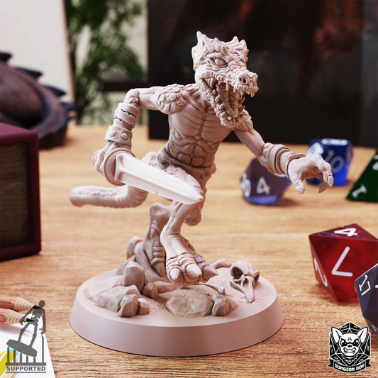 Kobold miniature by Dungeon Dog posed mid-leap with sword raised, on a detailed rocky base with bones.