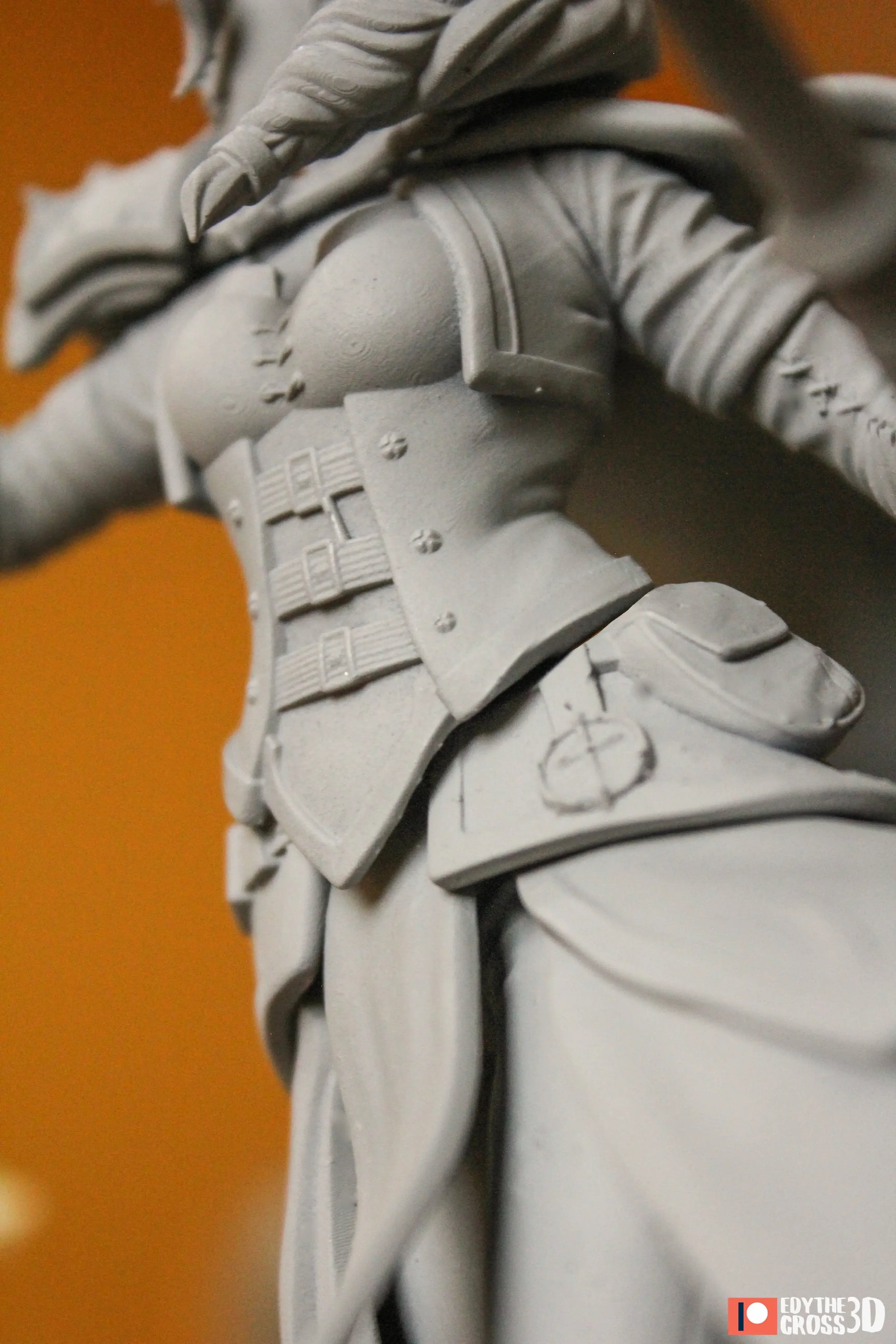 Gray sculpture of a character with detailed armor on an orange background
