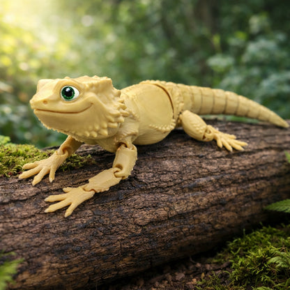 Articulated bearded dragon toy posed on a moss covered log outdoors, shown in beige with textured scales, jointed limbs, and a segmented tail against a blurred green forest background