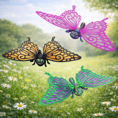 Three colorful 3D printed articulated butterfly toys with movable wings and segmented bodies displayed on a soft pastel background, showing customizable wing colors and detailed design.