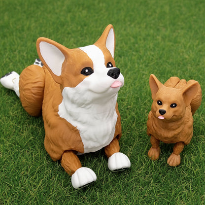 Two articulated corgi dog toys with movable legs and textured fur detail in brown and brown with white, one larger and one smaller, displayed on green grass background.