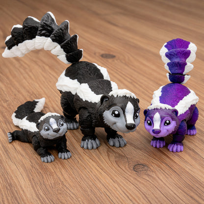 Three articulated skunk toys with poseable segmented bodies displayed on a wooden tabletop, featuring black and white skunks and a purple and white skunk with curled tails and detailed fur texture.