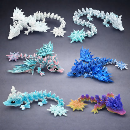 Articulated winter dragon toys with icy crystal spikes in blue, white, and pastel colors displayed on a clean neutral background.