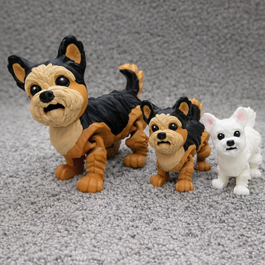 Articulated Yorkshire Terrier and West Highland Terrier toy figurines lineup in black tan and white colors displayed together on carpet.