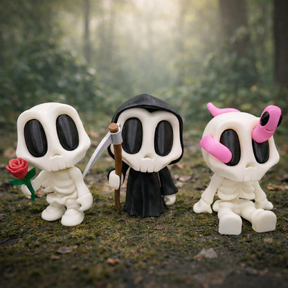 Three blob style skeleton toys with large black eyes standing side by side on a soft neutral background, featuring cute spooky character designs in white and black plastic