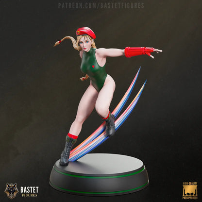 Front-facing view of Cammy from Street Fighter in green suit and red gauntlets, posed mid-attack