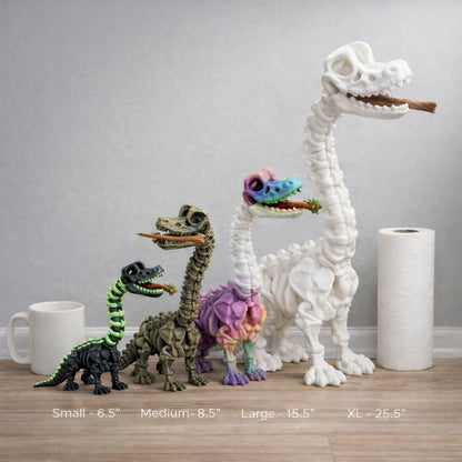 Set of dinosaur figurines in various sizes on a wooden floor with a plain wall background.