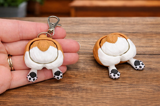 corgi butt-shaped keychain and toy on a wooden surface