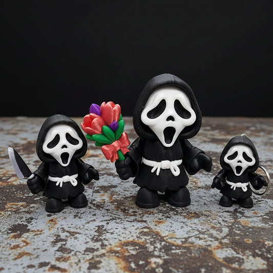 Chibi Ghost face toy figure available as a standalone toy, keychain, or magnet, shown holding optional flower bouquet or knife accessory on a textured display surface