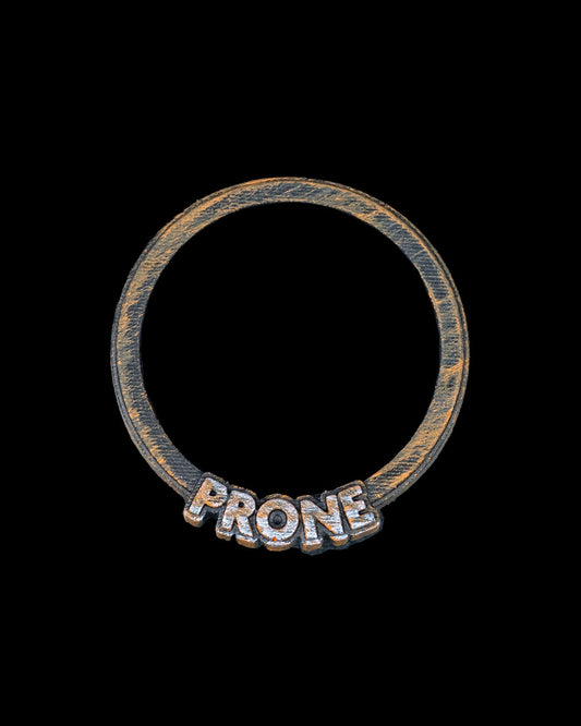 Close-up of orange and black "PRONE" ring for D&D miniatures, made from durable 3D printed plastic.
