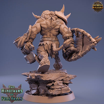 Minotaur figurine with armor and weapons on a gray background, featuring 'Daybreak Miniatures' branding.