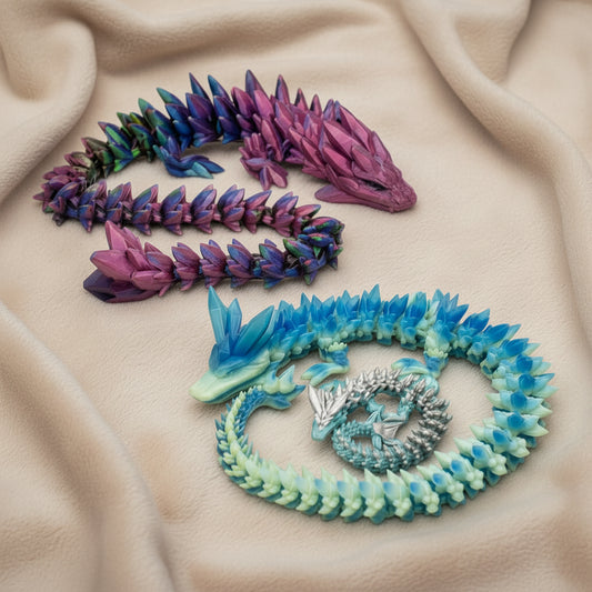 Large articulated dragons posed on a soft neutral fabric surface showing detailed sculpts flexible joints and bold crystal inspired colors