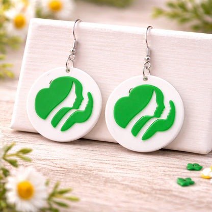 Pair of earrings with green leaf design on a white background