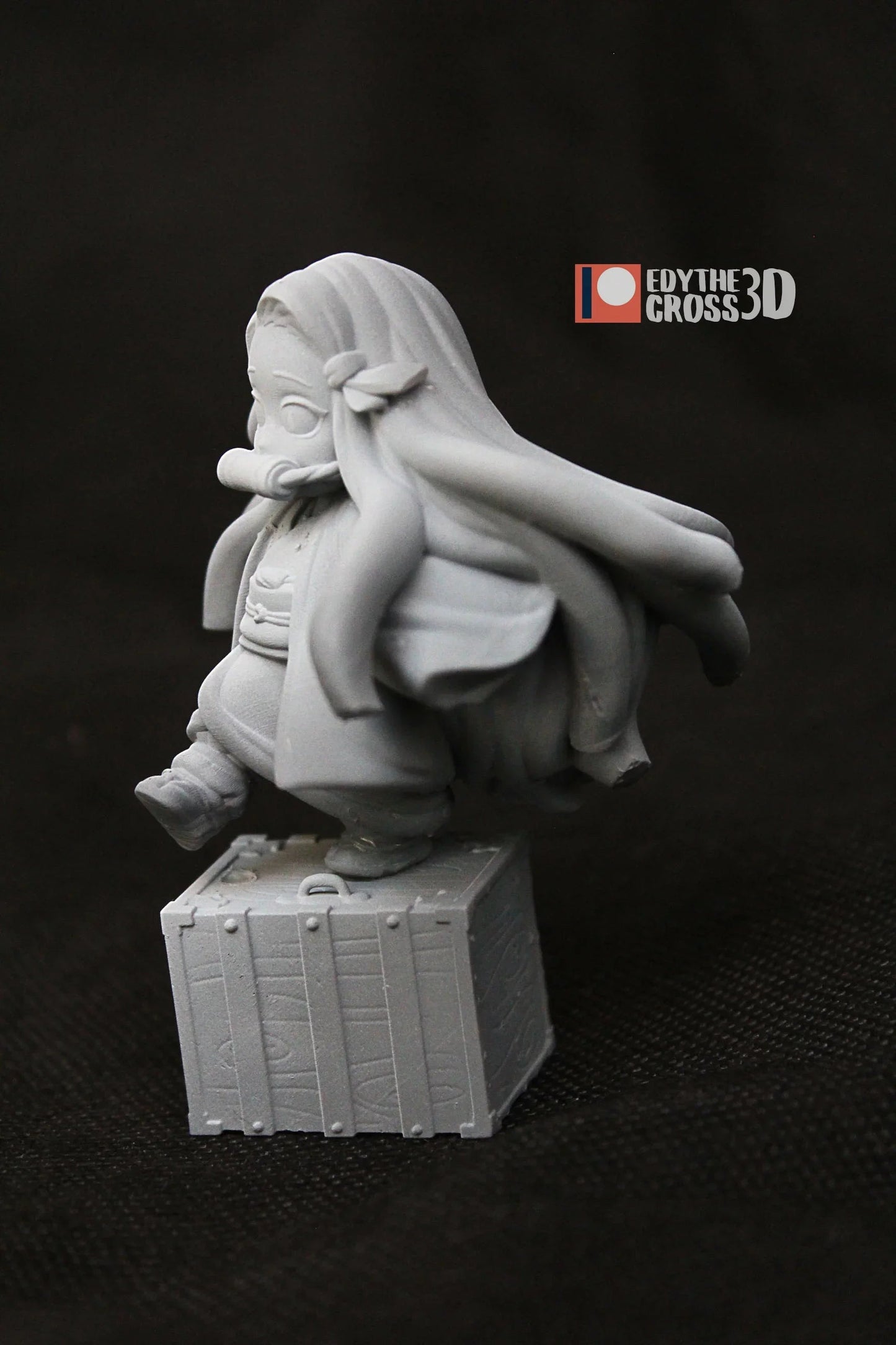 Back angle of Nezuko Kamado 3D printed figure highlighting long hair and wooden crate base