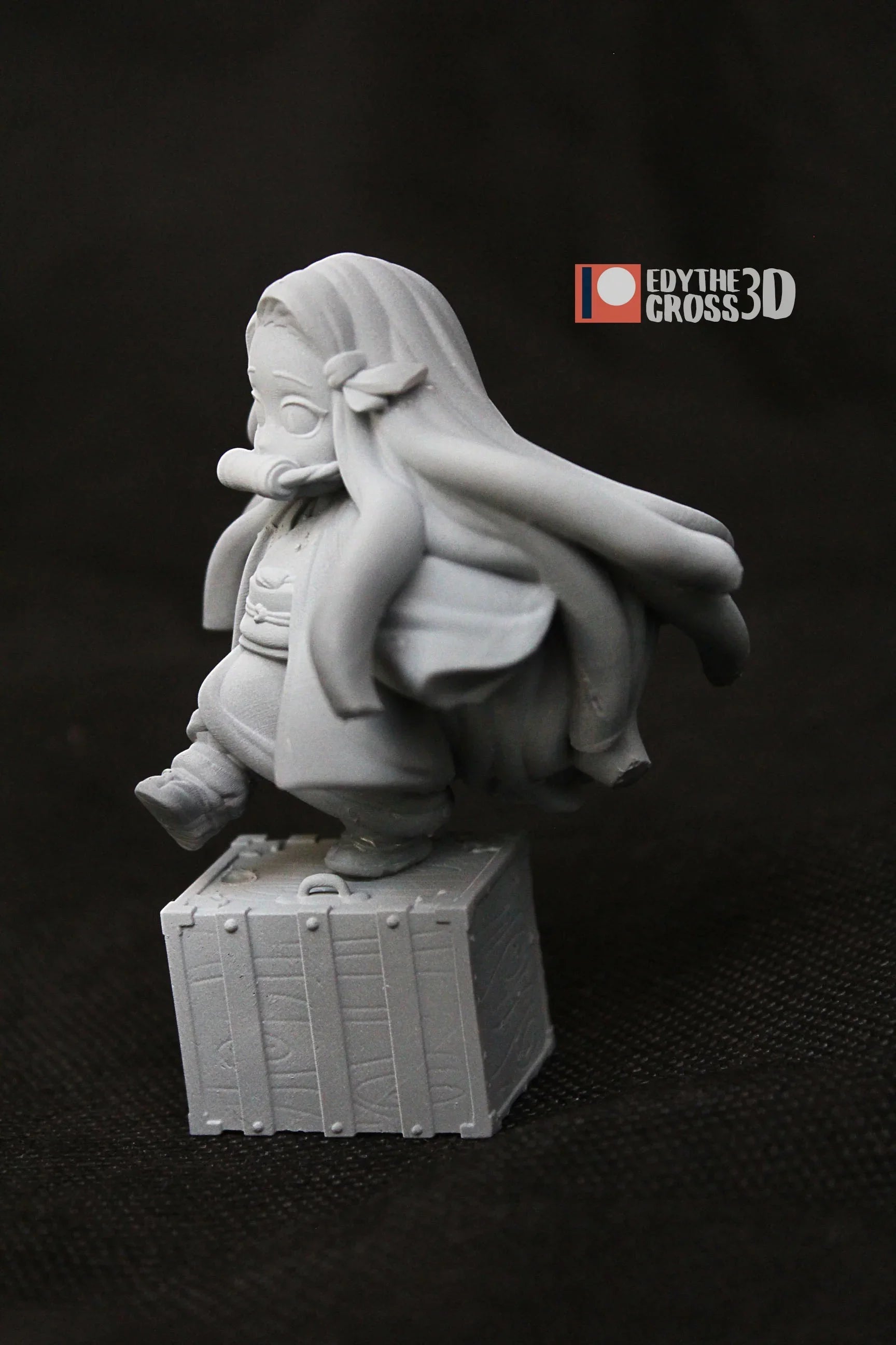 Back angle of Nezuko Kamado 3D printed figure highlighting long hair and wooden crate base