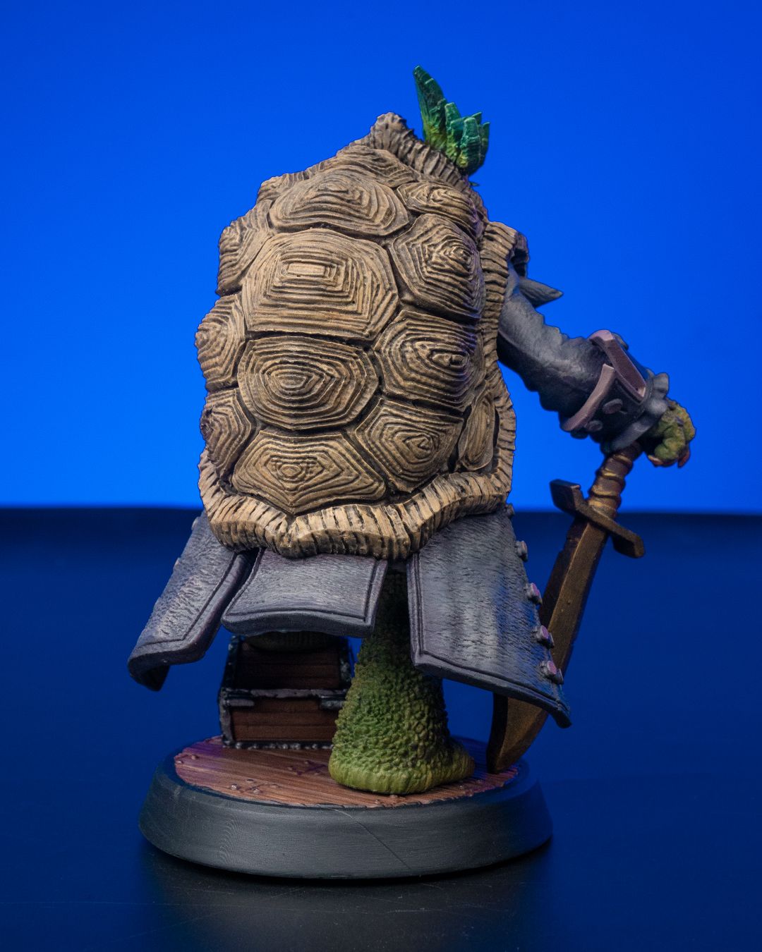 Krog resin pirate captain miniature figure for D&D and TTRPGs, shown in raw resin and painted versions, with sword and treasure chest base.