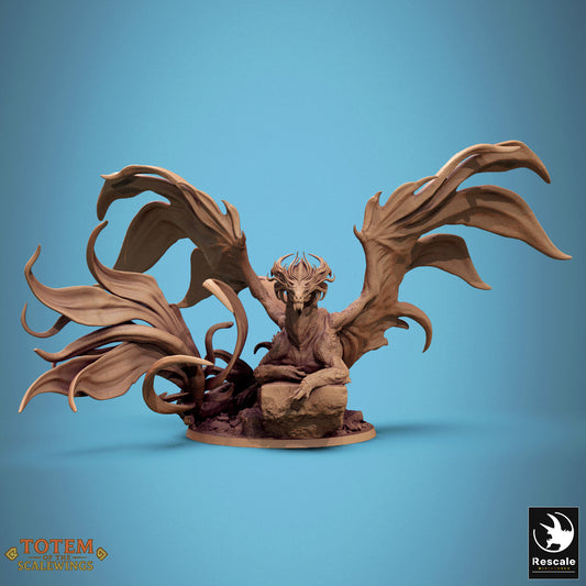 Brass dragon miniature with massive wings outstretched on a scenic rock base