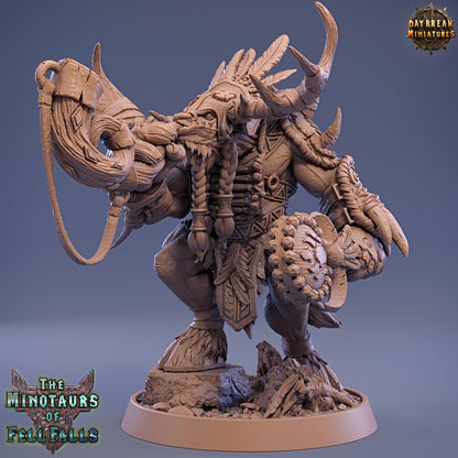 Wooden figurine of a minotaur with intricate details on a blue background, featuring 'Daybreak Miniatures' logo.