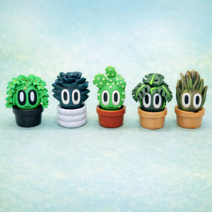 Toy succulent plant figures with pots, five colorful cartoon style faux succulents lined up on a soft pastel blue background, decorative desk toy plants in small pots