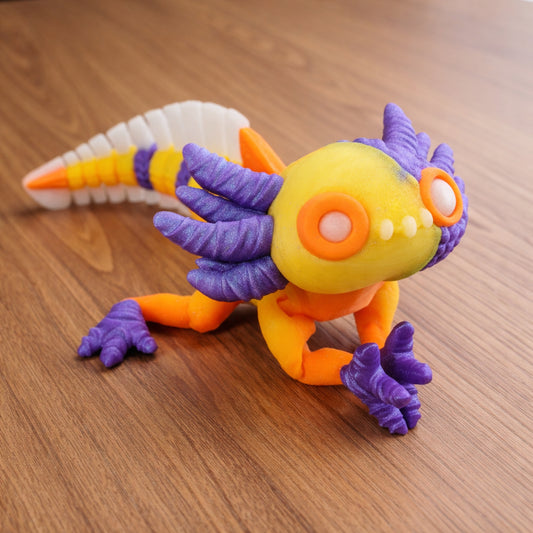 Colorful articulated axolotl toy on a brown surface