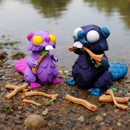 Two colorful articulated beaver toy figures with plastic branches on a rocky surface with water in the background