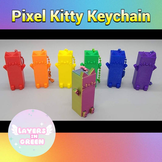 Pixel Kitty Keychains in rainbow colors – 3D printed blocky cat designs with keychain loops, made by Layers in Green.