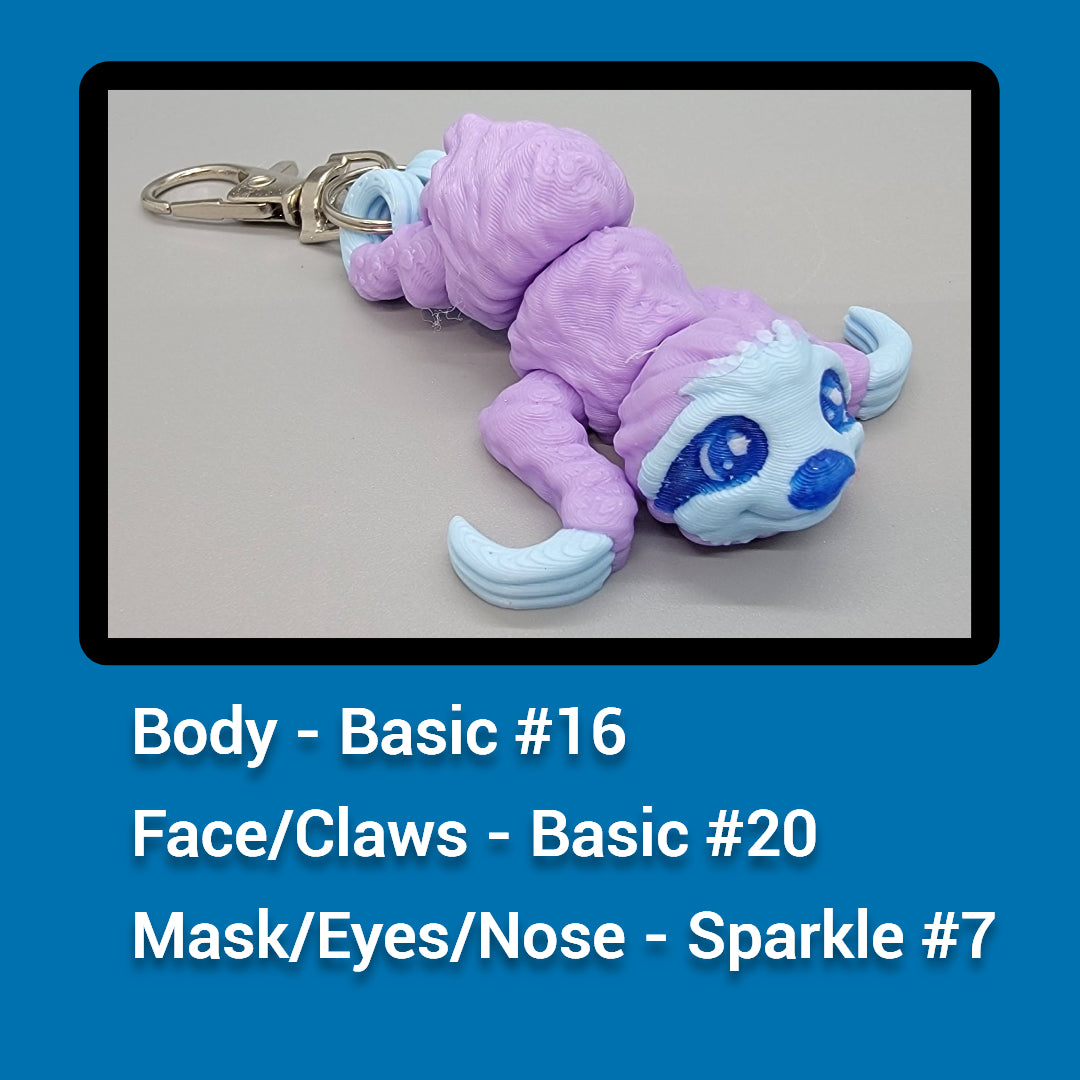 sloth keychain with text indicating parts and colors on a blue background