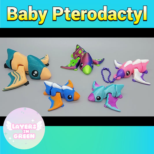 Baby Pterodactyl toys by Layers in Green – colorful 3D printed articulated dinosaurs in playful designs, some with attached keychain loops.