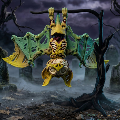Green and yellow zombie bat with eyes, exposed ribs, and spread wings hanging upside down from a black tree stand against a spooky graveyard backdrop.⠋