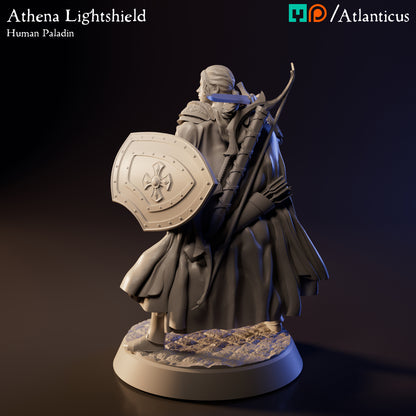 Left profile view of the unpainted resin Athena Lightshield miniature showcasing her large, ornate kite shield featuring a raised cross design.