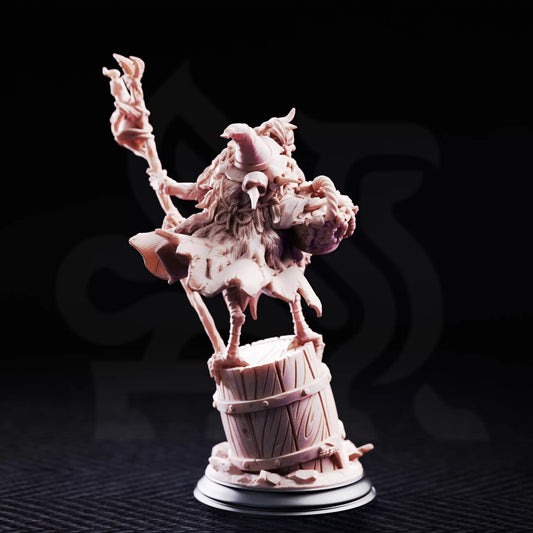 Rear render view of the Baba Yaga Ancient Witch miniature showing her bird mask, pointed hat, and woven basket.