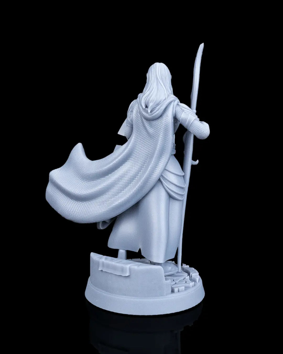 Rear view of the Bastion Female Elf Warrior resin miniature showing her long hair and billowing hooded cloak.