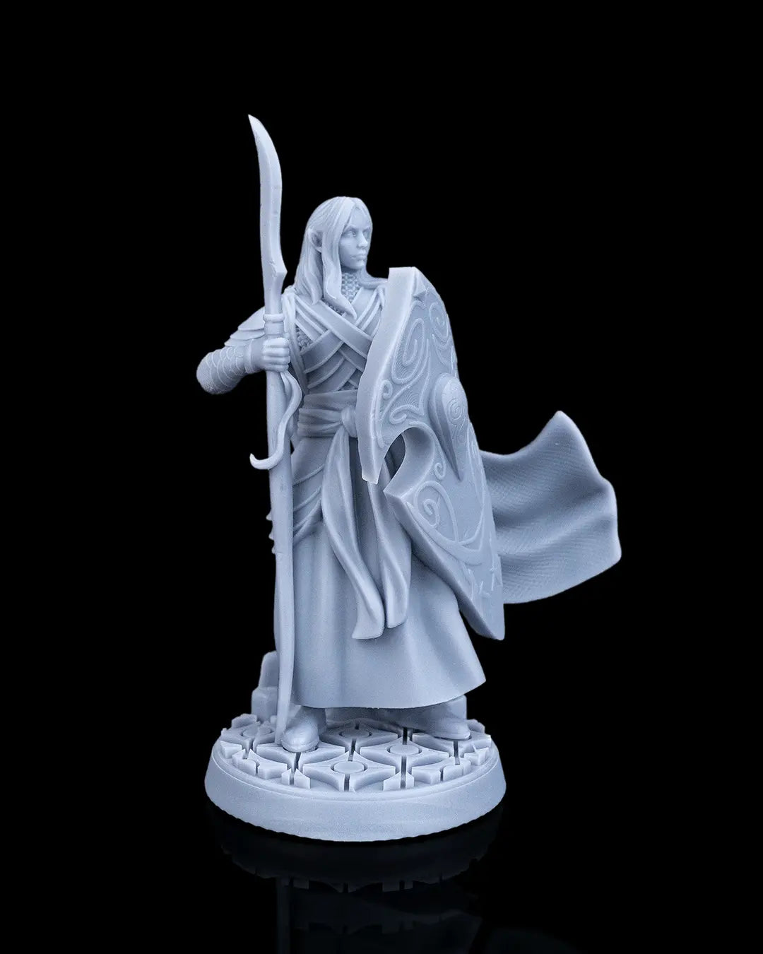 Left profile view of the Bastion Female Elf Warrior mini showing the detailed wrap layers of her bodice and spear length.