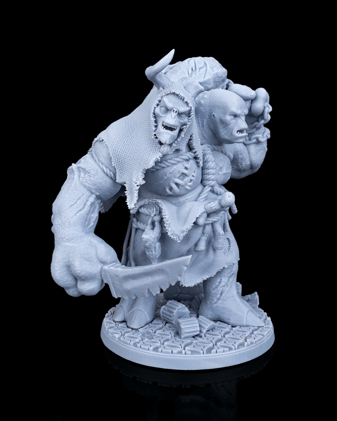 Brugtilda the Bloated two-headed giant resin miniature by Artificers Mini holding a serrated cleaver blade.