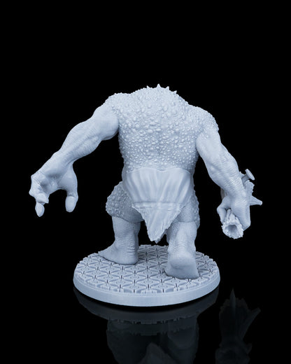 Rear view of Clubba the Troll resin miniature highlighting the dense, scaly skin and simple cloth loincloth.