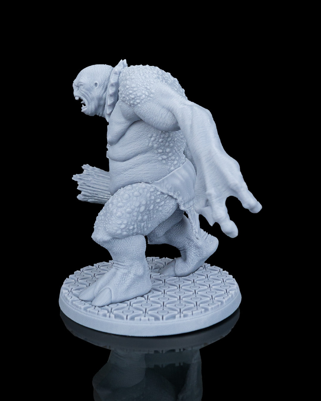 Left profile view of the Clubba the Troll dnd miniature showing his reaching claw and muscular posture.